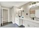 Bright bathroom featuring double vanity with a white countertop, and dark floor at 5668 Champion Way, Greenwood, IN 46143