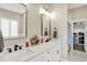 A bright bathroom with double vanity, marble countertop and a walk-in closet at 5668 Champion Way, Greenwood, IN 46143