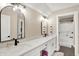 Bright bathroom with double vanity, black hardware, a large mirror, and a view of the shower area at 5668 Champion Way, Greenwood, IN 46143
