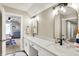 Spacious bathroom with double vanity, black hardware, a large mirror, and a view of the play area at 5668 Champion Way, Greenwood, IN 46143