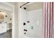 Bathroom with bathtub and shower featuring black fixtures and a pink shower curtain at 5668 Champion Way, Greenwood, IN 46143