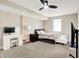 Comfortable carpeted bedroom with a ceiling fan, entertainment center and two beds at 5668 Champion Way, Greenwood, IN 46143