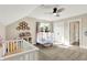Airy bedroom featuring a crib, a mini trampoline, and a white shelf filled with toys at 5668 Champion Way, Greenwood, IN 46143
