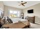 A lovely bedroom with large window, ceiling fan, and wood furniture at 5668 Champion Way, Greenwood, IN 46143