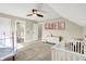 Bright bedroom featuring a crib, a mini trampoline, and framed pictures on the wall at 5668 Champion Way, Greenwood, IN 46143