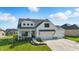 Stunning two-story home featuring white siding, black accents, a covered porch, and a three-car garage at 5668 Champion Way, Greenwood, IN 46143