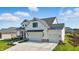 Beautiful two-story home featuring white siding, black accents, a covered porch, and a convenient three-car garage at 5668 Champion Way, Greenwood, IN 46143