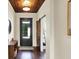 Warm foyer featuring dark wood flooring, a wooden ceiling, and a stylish barn door leading to another room at 5668 Champion Way, Greenwood, IN 46143