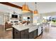 A gorgeous kitchen with an island transitions into an eat-in space and great room at 5668 Champion Way, Greenwood, IN 46143