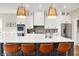 Stylish kitchen island with seating, modern pendant lighting, and stainless-steel refrigerator at 5668 Champion Way, Greenwood, IN 46143