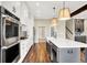 Well-equipped kitchen with stainless-steel appliances, a large island, and modern pendant lighting at 5668 Champion Way, Greenwood, IN 46143