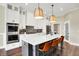 A spacious kitchen with quartz countertop island, stainless steel appliances, and ample cabinetry at 5668 Champion Way, Greenwood, IN 46143