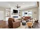 Bright living room features a cozy fireplace, ceiling fan, and stylish furnishings at 5668 Champion Way, Greenwood, IN 46143