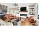 Open concept living room boasts fireplace, built-in shelving, and comfortable seating at 5668 Champion Way, Greenwood, IN 46143