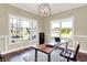 Bright office space with large windows, a modern desk, comfortable chair, and decorative chandelier at 5668 Champion Way, Greenwood, IN 46143