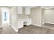 Bright, neutral office space with white built-in desk and cabinets, and gray carpet at 5668 Champion Way, Greenwood, IN 46143