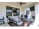 Relaxing covered patio featuring comfortable seating, an outdoor television and a fireplace at 5668 Champion Way, Greenwood, IN 46143