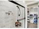 Luxurious bathroom with tiled shower, glass enclosure, and view of the walk-in closet at 5668 Champion Way, Greenwood, IN 46143