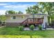 Back of house with wooden deck, well-maintained lawn and garden at 586 Shady Creek Dr, Greenwood, IN 46142