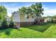 Well-manicured backyard with lush green lawn, mature trees, and house exterior at 586 Shady Creek Dr, Greenwood, IN 46142