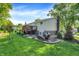 Exterior view of backyard with lush green lawn, a deck and mature trees at 586 Shady Creek Dr, Greenwood, IN 46142