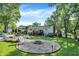 Large backyard featuring a fire pit area, patio furniture, and a well-maintained lawn at 586 Shady Creek Dr, Greenwood, IN 46142