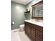 Charming bathroom featuring a wood vanity, white countertops, and decorative tile flooring at 586 Shady Creek Dr, Greenwood, IN 46142