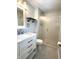 Cozy bathroom with gray tile floors, white vanity, a frosted glass shower door, and stylish fixtures at 586 Shady Creek Dr, Greenwood, IN 46142