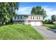 Charming split-level home featuring a well-manicured lawn and attached two-car garage at 586 Shady Creek Dr, Greenwood, IN 46142