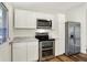 Updated kitchen with stainless steel appliances, white cabinets, modern lighting, and durable flooring at 586 Shady Creek Dr, Greenwood, IN 46142