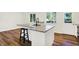 Bright kitchen featuring an island with granite countertops, black faucet, and updated appliances at 586 Shady Creek Dr, Greenwood, IN 46142