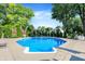 Backyard featuring an inground pool with concrete surround, lush greenery, and mature trees at 586 Shady Creek Dr, Greenwood, IN 46142