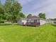 Expansive backyard view showcasing a well-maintained lawn and a cozy wooden deck at 624 10Th St, Chesterfield, IN 46017