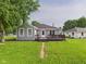 Charming home featuring a spacious backyard with a wooden deck, perfect for outdoor entertaining at 624 10Th St, Chesterfield, IN 46017