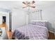 Cozy bedroom with hardwood floors, ceiling fan, and a comfortable bed at 624 10Th St, Chesterfield, IN 46017
