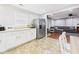 Open kitchen featuring stainless steel refrigerator and adjacent living room at 624 10Th St, Chesterfield, IN 46017