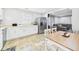 Bright kitchen with white cabinets, stainless steel refrigerator, and an adjacent dining area at 624 10Th St, Chesterfield, IN 46017