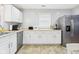 Modern kitchen showcasing white cabinetry, stainless steel appliances, and plenty of counter space at 624 10Th St, Chesterfield, IN 46017