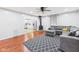 Bright living room with hardwood floors, a large gray sectional, and an open layout to the kitchen at 624 10Th St, Chesterfield, IN 46017