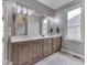 Bathroom with double sinks, a large mirror and a window with a view to the outside at 6525 Carolina Blvd, Indianapolis, IN 46217