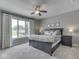 Cozy bedroom with a ceiling fan, neutral color scheme, and large windows offering natural light at 6525 Carolina Blvd, Indianapolis, IN 46217