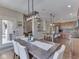 Open-concept dining area leading into a modern kitchen with an island and stainless steel appliances at 6525 Carolina Blvd, Indianapolis, IN 46217