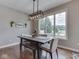 Cozy dining area featuring a window view, modern lighting and hardwood floors at 6525 Carolina Blvd, Indianapolis, IN 46217