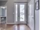 Bright foyer with hardwood floors, decorative glass front door and adjacent bedroom at 6525 Carolina Blvd, Indianapolis, IN 46217