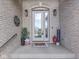 Welcoming front entrance with a decorated porch, charming décor and glass paneled door at 6525 Carolina Blvd, Indianapolis, IN 46217