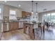Bright kitchen featuring stainless steel appliances, tile backsplash, and an island with seating next to dining area at 6525 Carolina Blvd, Indianapolis, IN 46217