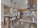 Close-up of a kitchen with an island, stainless steel appliances, granite countertops, and hardwood floors at 6525 Carolina Blvd, Indianapolis, IN 46217