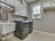 Functional laundry room equipped with a sink, washer, dryer, and ample storage in white cabinets at 6525 Carolina Blvd, Indianapolis, IN 46217