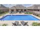 Inviting backyard with a sparkling in-ground pool, lounge chairs, and an outdoor dining area at 6525 Carolina Blvd, Indianapolis, IN 46217