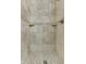 Walk-in shower with stone tile, mosaic accents, and corner shelves at 6525 Carolina Blvd, Indianapolis, IN 46217